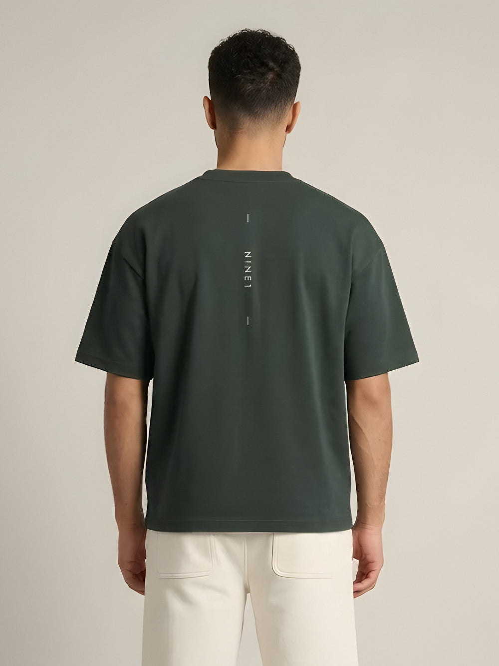 NINE1 Spine Oversized Tee in Dark Green (N1T07), back view showing the spine print