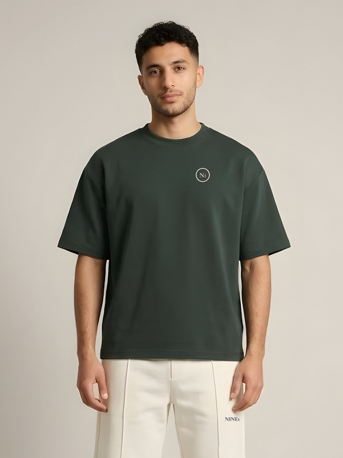 NINE1 Spine Oversized Tee in Dark Green (N1T07), front with embroidered N1 at the left chest