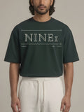 Gallery Oversized Tee in Dark Green, N1T21, wide cream outline NINE1 wordmark across the chest